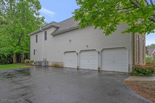 102 Independence Dr, Bernards Twp, NJ 07920 - view of side of home with asphalt driveway, central AC, and a garage
