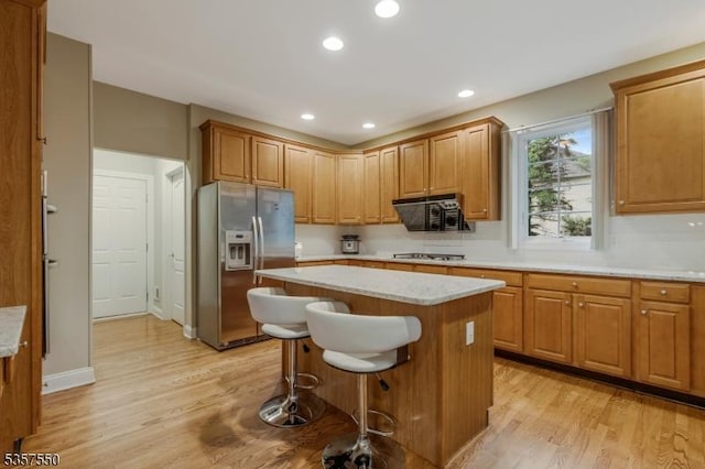 102 Independence Dr, Bernards Twp, NJ 07920 - kitchen featuring appliances with stainless steel finishes, light wood-style floors, a kitchen island, a kitchen bar, and recessed lighting