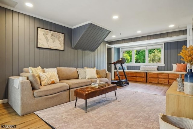 living room featuring wood finished floors, ornamental molding, and recessed lighting