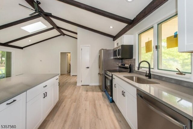 113 Spook Ridge Rd, Montague Twp, NJ 07827 - kitchen featuring appliances with stainless steel finishes, a sink, light wood finished floors, white cabinetry, and decorative backsplash