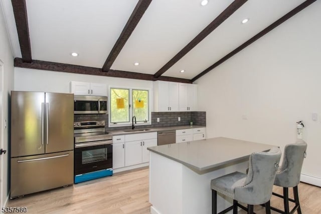 113 Spook Ridge Rd, Montague Twp, NJ 07827 - kitchen featuring stainless steel appliances, decorative backsplash, light wood-style floors, a breakfast bar area, and white cabinetry