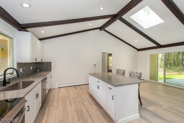 113 Spook Ridge Rd, Montague Twp, NJ 07827 - kitchen with a sink, light wood-style flooring, a skylight, a kitchen bar, and baseboard heating