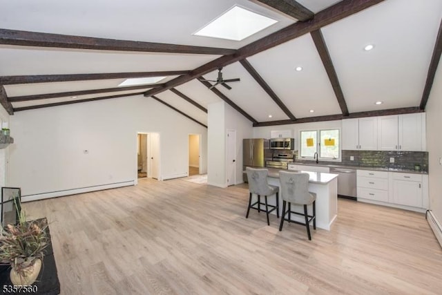 113 Spook Ridge Rd, Montague Twp, NJ 07827 - kitchen featuring stainless steel appliances, a skylight, baseboard heating, a kitchen bar, and a kitchen island