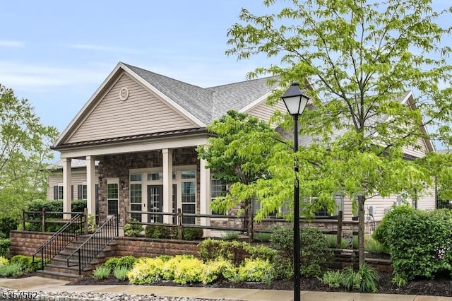 18 Brompton Pl, Randolph Twp, NJ 07869 - view of front of house featuring stone siding, roof with shingles, and a porch