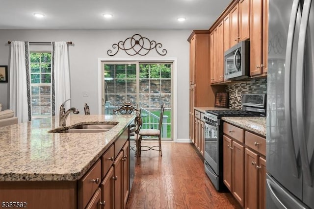 18 Brompton Pl, Randolph Twp, NJ 07869 - kitchen featuring stainless steel appliances, a sink, dark wood-style floors, brown cabinets, and light stone countertops