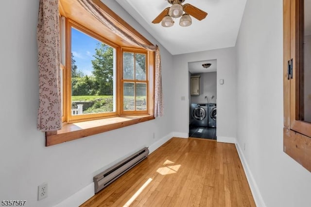 392 Pittstown Rd, Franklin Twp, NJ 08867 - hall with baseboard heating, washer and clothes dryer, light wood-style flooring, and baseboards