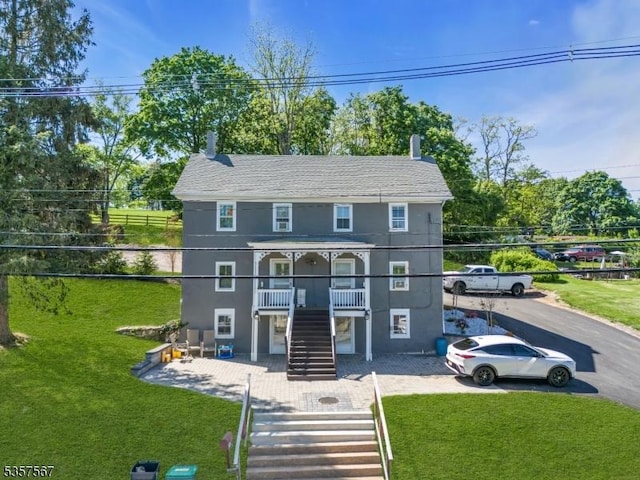 392 Pittstown Rd, Franklin Twp, NJ 08867 - view of front of home featuring stairway, a front lawn, and stucco siding