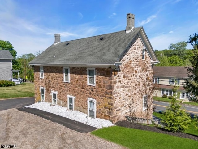 392 Pittstown Rd, Franklin Twp, NJ 08867 - rear view of property featuring a chimney, stone siding, and roof with shingles