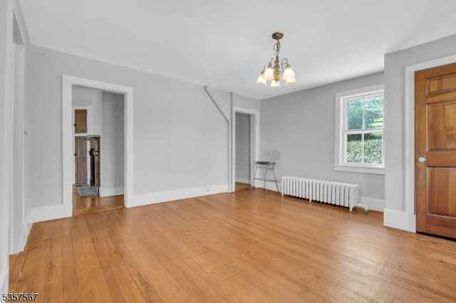 392 Pittstown Rd, Franklin Twp, NJ 08867 - empty room with radiator, a chandelier, light wood-style floors, and baseboards