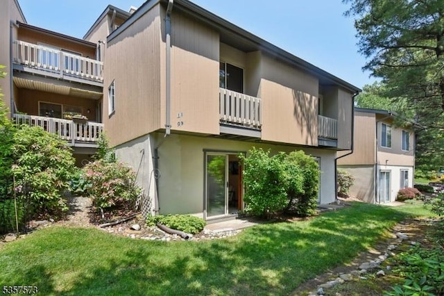 9 Larkin Unit 9, West Orange Twp, NJ 07052 - back of property with a balcony, stucco siding, and a lawn