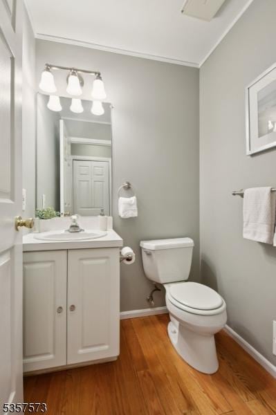 9 Larkin Unit 9, West Orange Twp, NJ 07052 - bathroom with toilet, wood finished floors, vanity, baseboards, and ornamental molding