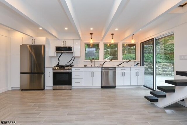 203 Stanhope Rd, Sparta Twp, NJ 07871 - kitchen with stainless steel appliances, white cabinets, light countertops, backsplash, and recessed lighting