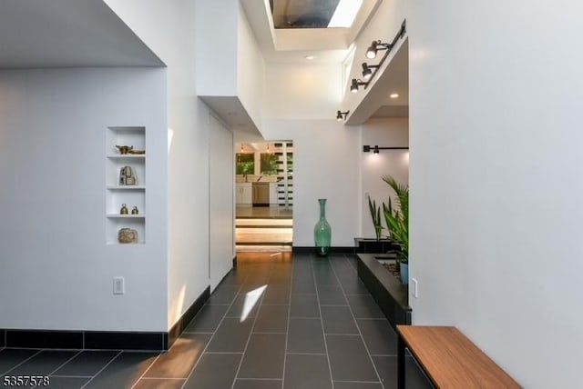 203 Stanhope Rd, Sparta Twp, NJ 07871 - corridor featuring dark tile patterned floors, built in features, and baseboards