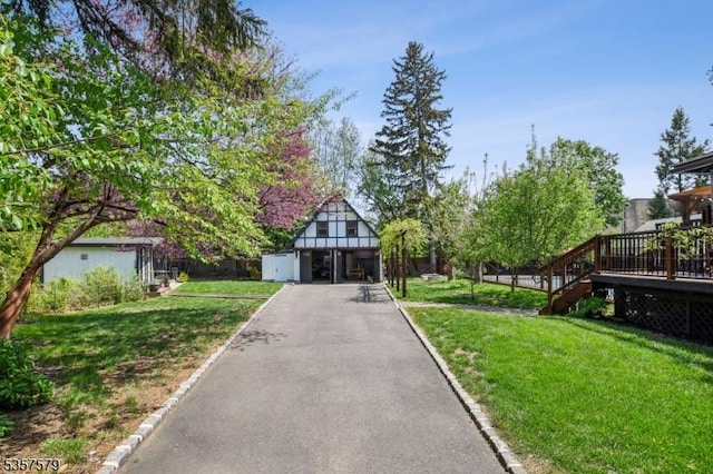 view of home's community featuring a lawn and a deck