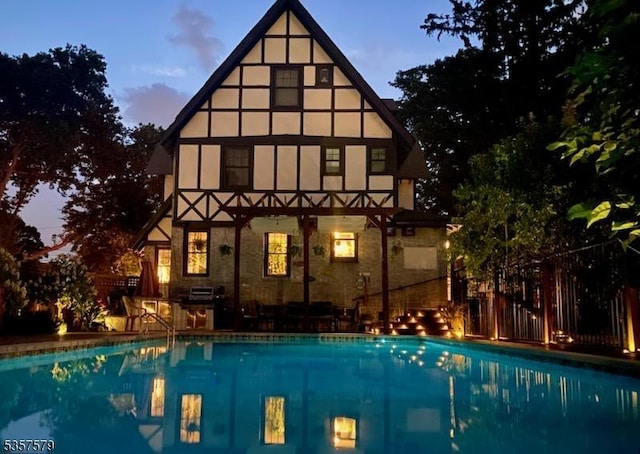 127 Severin Ct, Cranford Twp, NJ 07016 - back of house with an outdoor pool, fence, and stucco siding