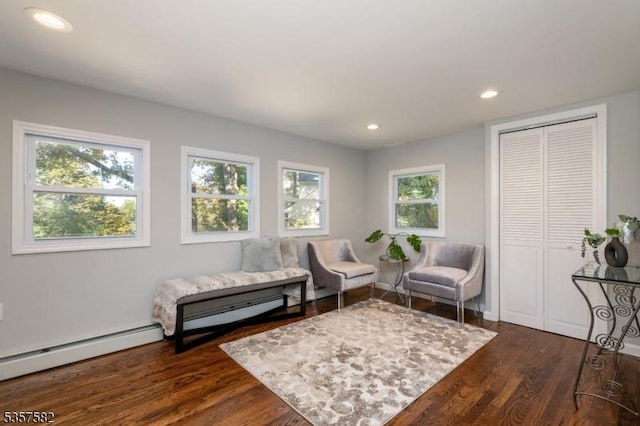 living area with dark wood-style flooring, recessed lighting, and baseboard heating