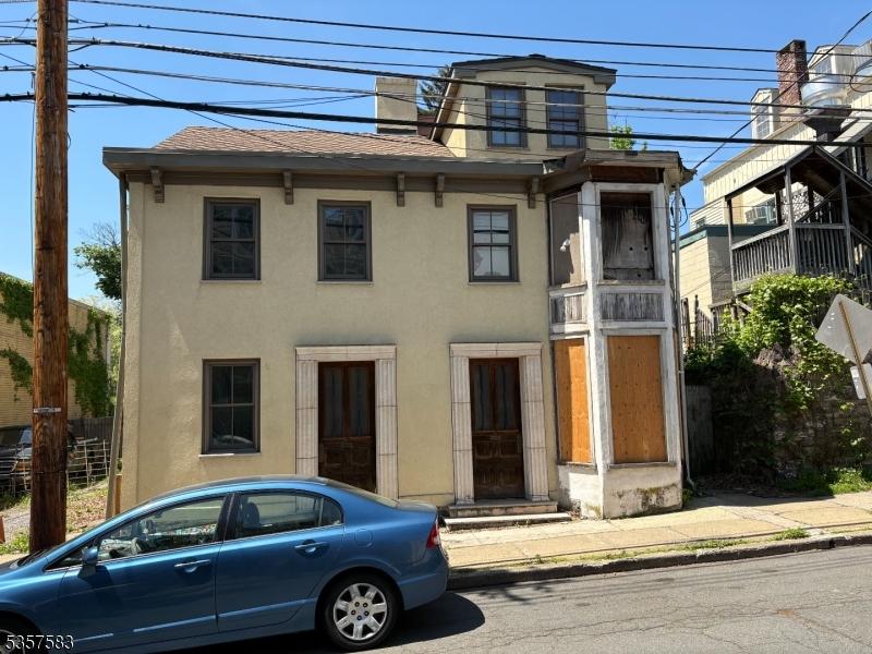 17-21 S Union St, Lambertville City, NJ 08530 - view of front facade featuring stucco siding, roof with shingles, and a chimney