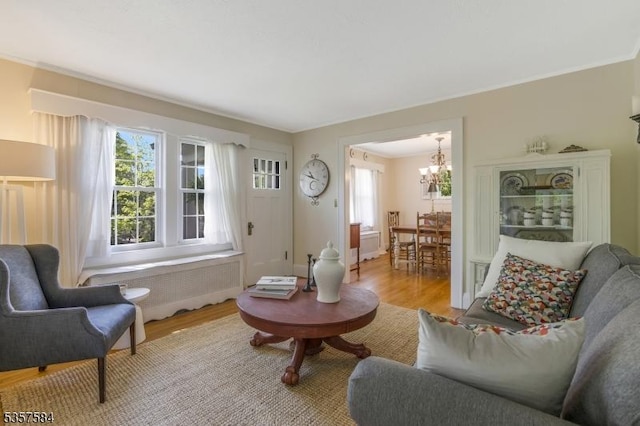 living area with a chandelier and light wood-type flooring