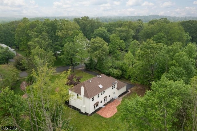 view from above of property featuring a heavily wooded area