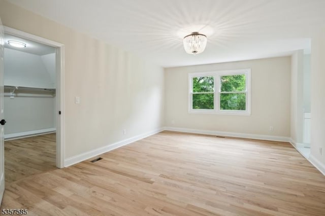 empty room with wood finished floors and baseboards