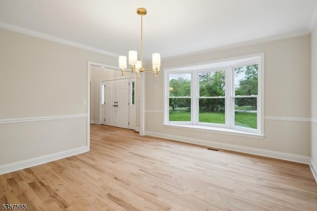 unfurnished dining area with a chandelier, baseboards, crown molding, and light wood-type flooring