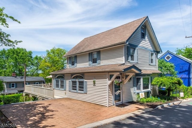 view of front of house featuring roof with shingles