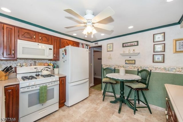 kitchen featuring white appliances, light countertops, ceiling fan, recessed lighting, and ornamental molding