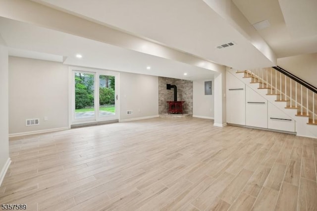 25 Woodcliff Dr, Madison Boro, NJ 07940 - unfurnished living room featuring a wood stove, light wood finished floors, stairs, and recessed lighting