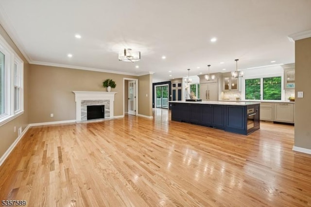 25 Woodcliff Dr, Madison Boro, NJ 07940 - unfurnished living room with plenty of natural light, light wood-style floors, a chandelier, recessed lighting, and ornamental molding