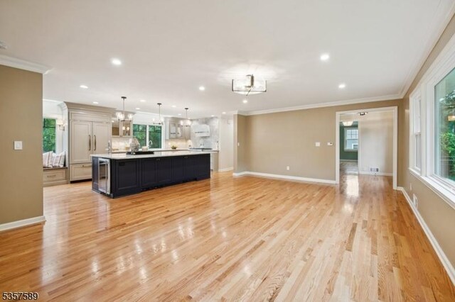 25 Woodcliff Dr, Madison Boro, NJ 07940 - living room featuring ornamental molding, recessed lighting, healthy amount of natural light, light wood-type flooring, and wine cooler