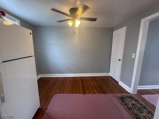 unfurnished dining area with ceiling fan, wood finished floors, and baseboards