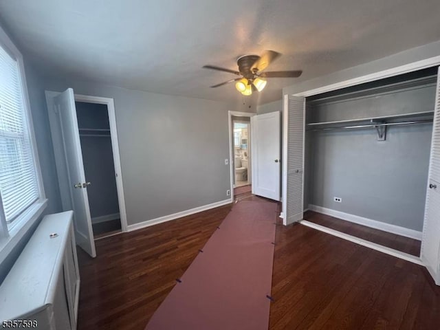 unfurnished bedroom featuring wood finished floors, baseboards, and a ceiling fan