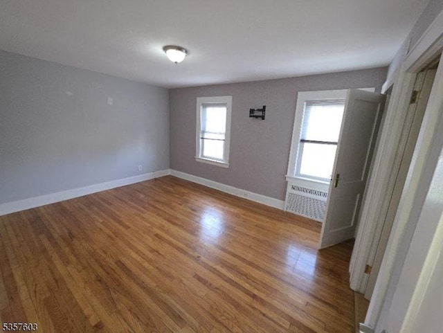 280 Fitzpatrick St, Hillside Twp, NJ 07205 - unfurnished room featuring wood finished floors, baseboards, and radiator