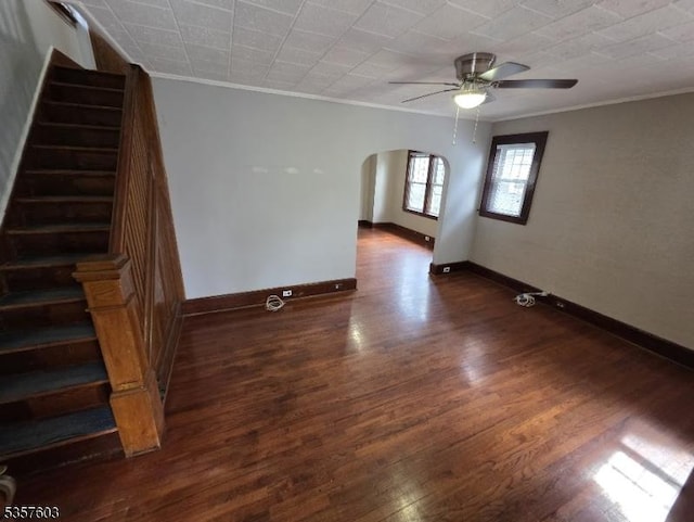 280 Fitzpatrick St, Hillside Twp, NJ 07205 - empty room featuring crown molding, arched walkways, stairs, dark wood-style floors, and a ceiling fan