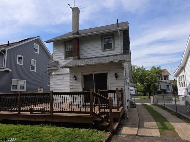 280 Fitzpatrick St, Hillside Twp, NJ 07205 - back of house with a deck, a shingled roof, fence, and a chimney