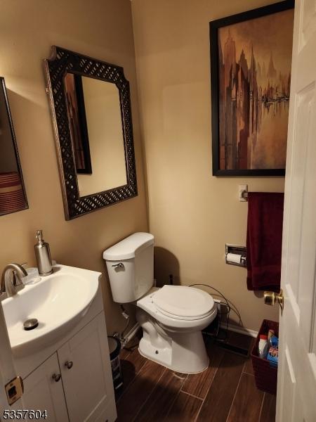 115 Seminole Rd Unit 115, Andover Twp, NJ 07848 - bathroom with toilet, wood finished floors, vanity, and baseboards