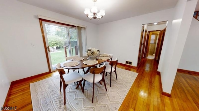 2764 Meister Ave, Union Twp, NJ 07083 - dining space with light wood-style floors, a chandelier, and baseboards