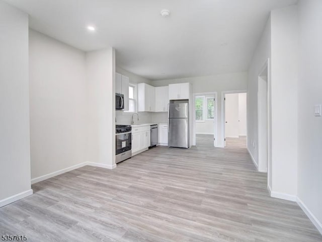 191 Matthew St, City Of Orange Twp, NJ 07050 - kitchen featuring appliances with stainless steel finishes, white cabinetry, baseboards, a sink, and light countertops