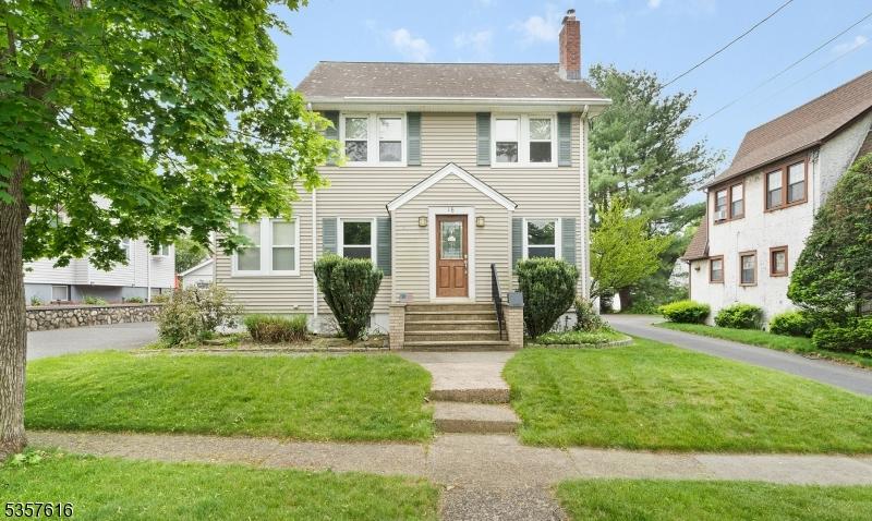 16 Suncrest Ave, North Haledon Boro, NJ 07508 - view of front facade with a chimney and a front yard