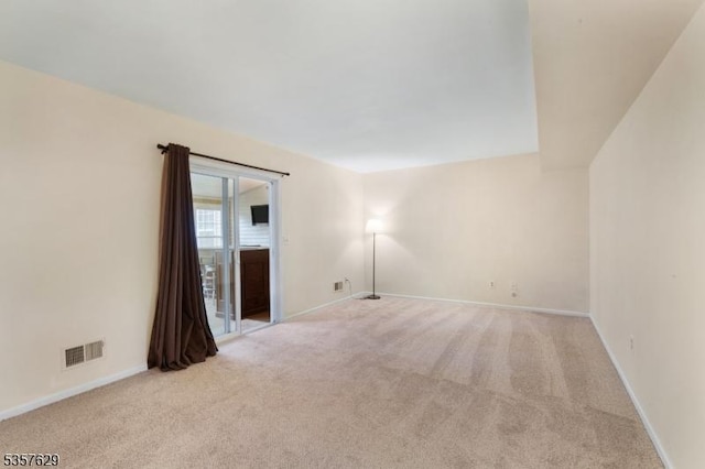 carpeted empty room with baseboards