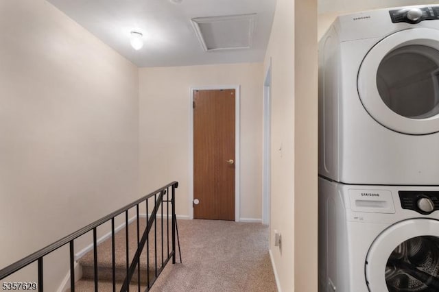 laundry room featuring stacked washer and clothes dryer, light carpet, and baseboards