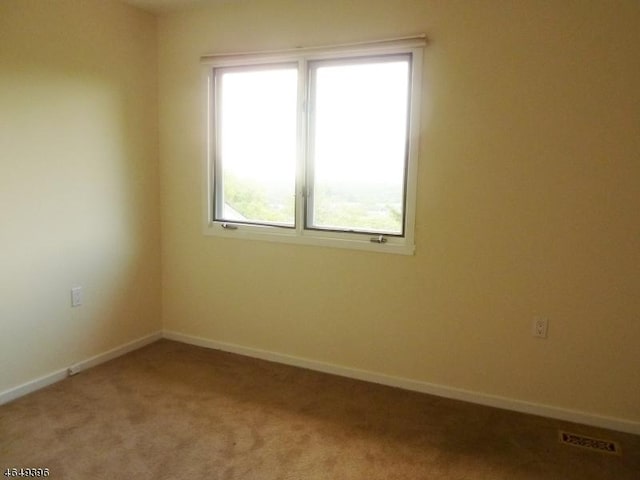 empty room with light carpet and baseboards