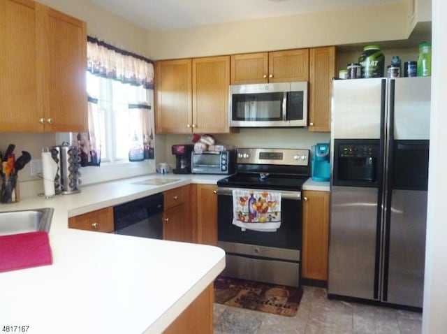 kitchen with stainless steel appliances, light countertops, and brown cabinetry