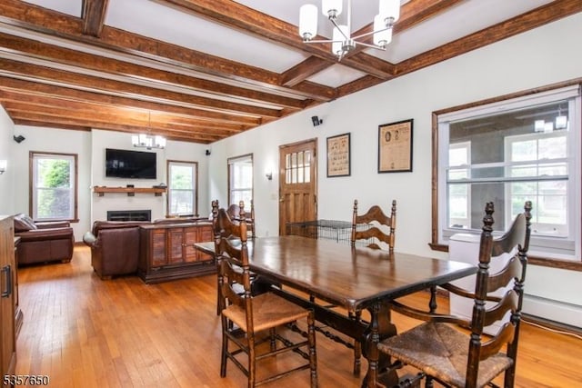 100 W Hanover Ave, Morris Twp, NJ 07950 - dining space with a chandelier, beamed ceiling, light wood finished floors, and a fireplace