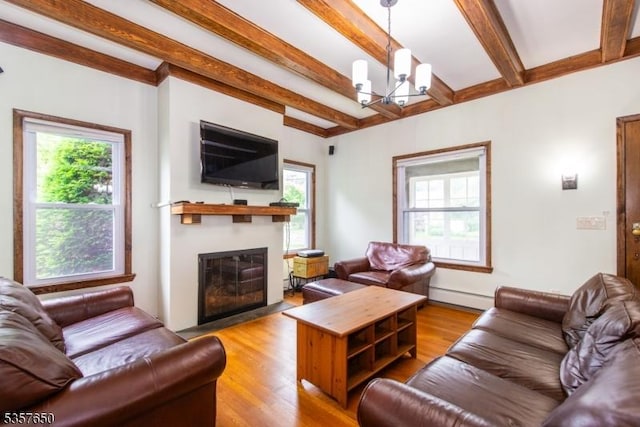 100 W Hanover Ave, Morris Twp, NJ 07950 - living area featuring a baseboard radiator, a chandelier, beamed ceiling, a fireplace with flush hearth, and healthy amount of natural light