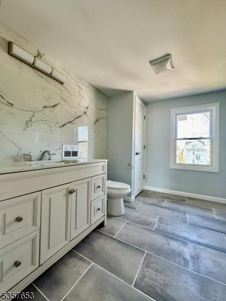 261 Hickory St, City Of Orange Twp, NJ 07050 - bathroom featuring vanity, healthy amount of natural light, toilet, and baseboards