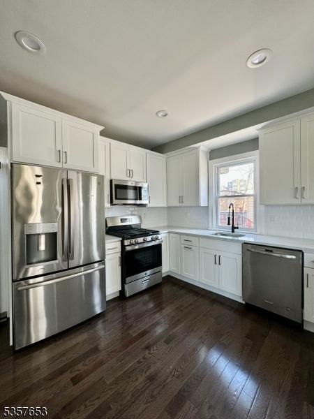 261 Hickory St, City Of Orange Twp, NJ 07050 - kitchen featuring stainless steel appliances, a sink, light countertops, white cabinetry, and recessed lighting