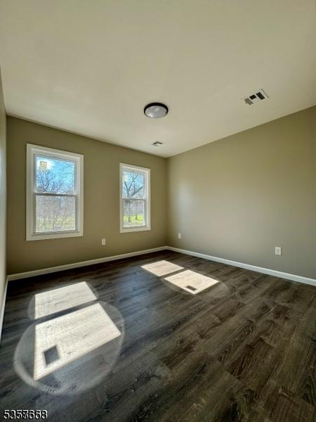 261 Hickory St, City Of Orange Twp, NJ 07050 - empty room featuring baseboards and dark wood-style flooring