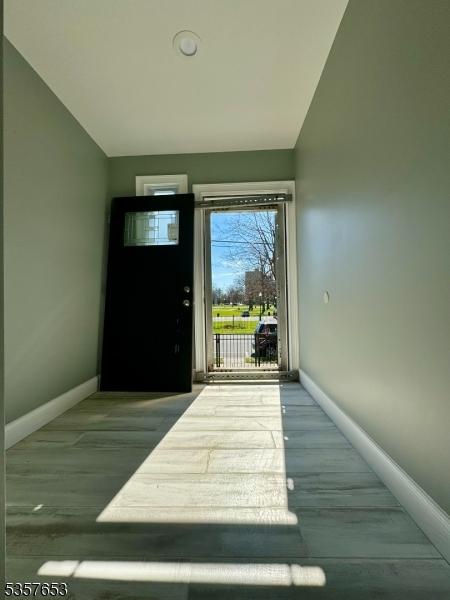 261 Hickory St, City Of Orange Twp, NJ 07050 - entrance foyer featuring baseboards and vaulted ceiling