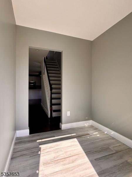261 Hickory St, City Of Orange Twp, NJ 07050 - spare room with baseboards, wood finished floors, and stairs